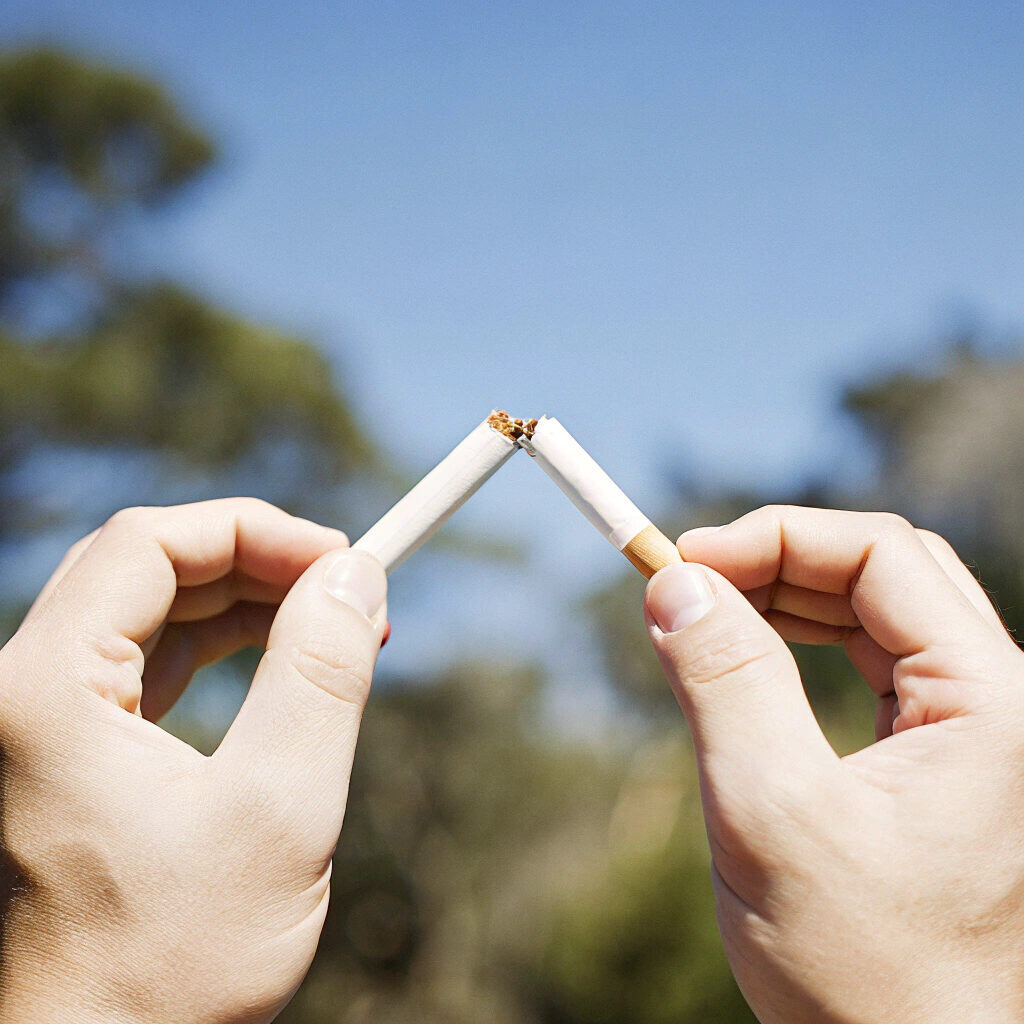 hands breaking smoke in half