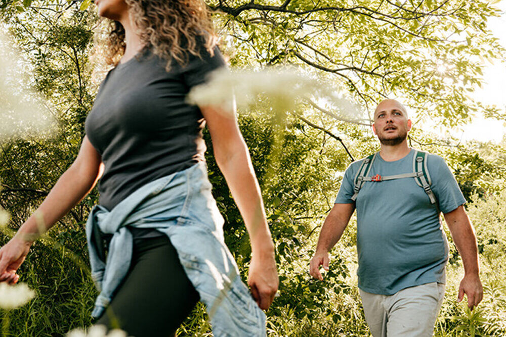 Man and woman with obesity walking outside