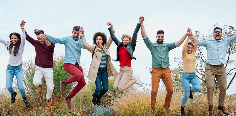 group of friends outside jumping